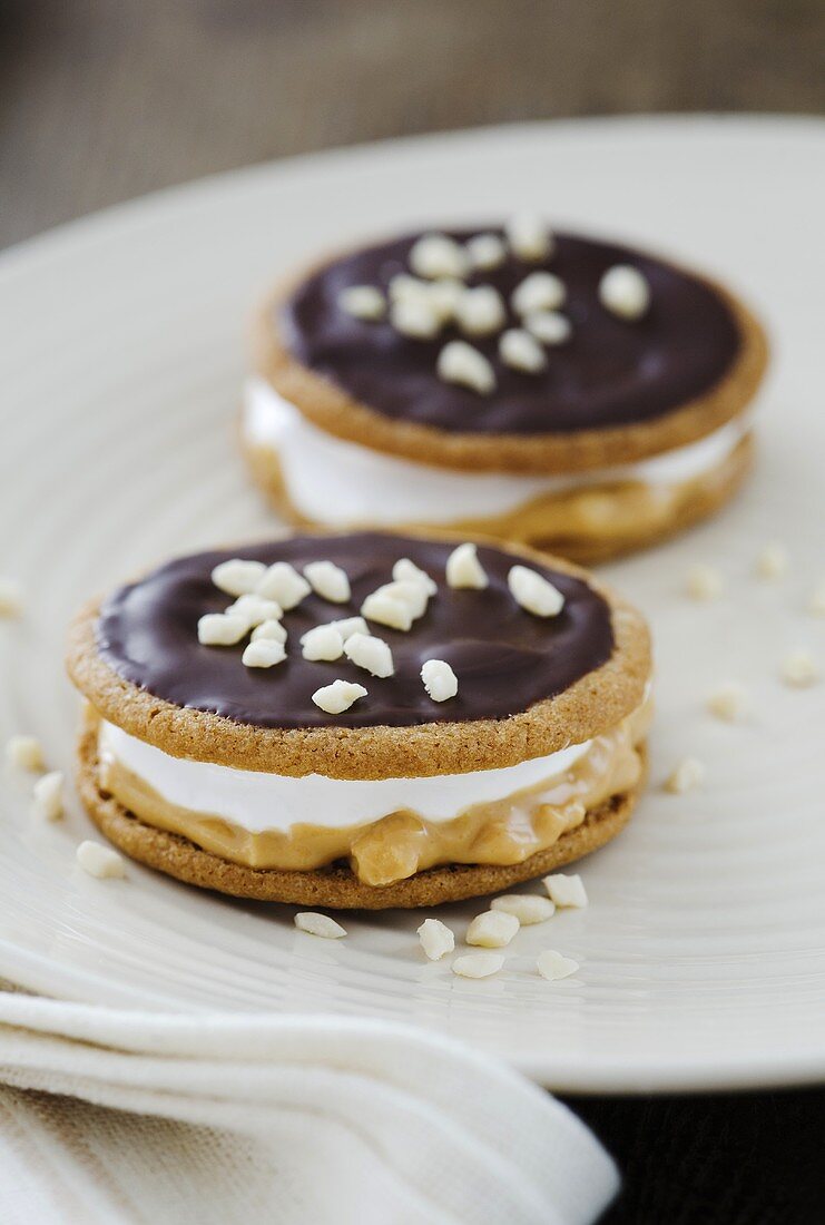 Moon pies (biscuits with a marshmallow filling) with chocolate icing, peanut butter and nuts