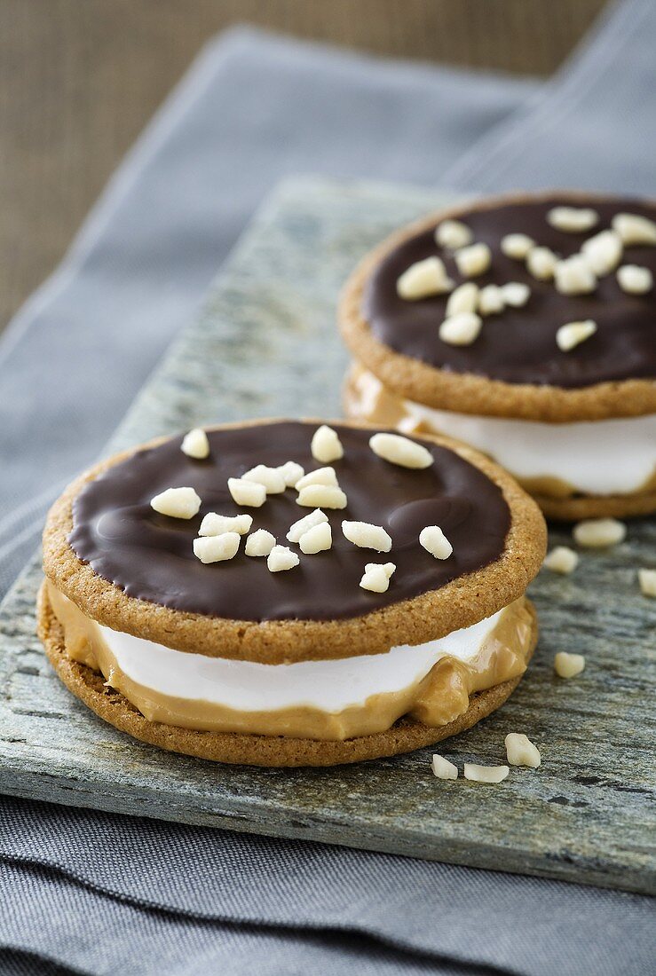 Moon pies (biscuits with a marshmallow filling) with chocolate icing, peanut butter and nuts