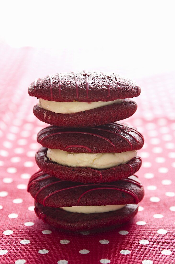 A stack of three raspberry whoopie pies