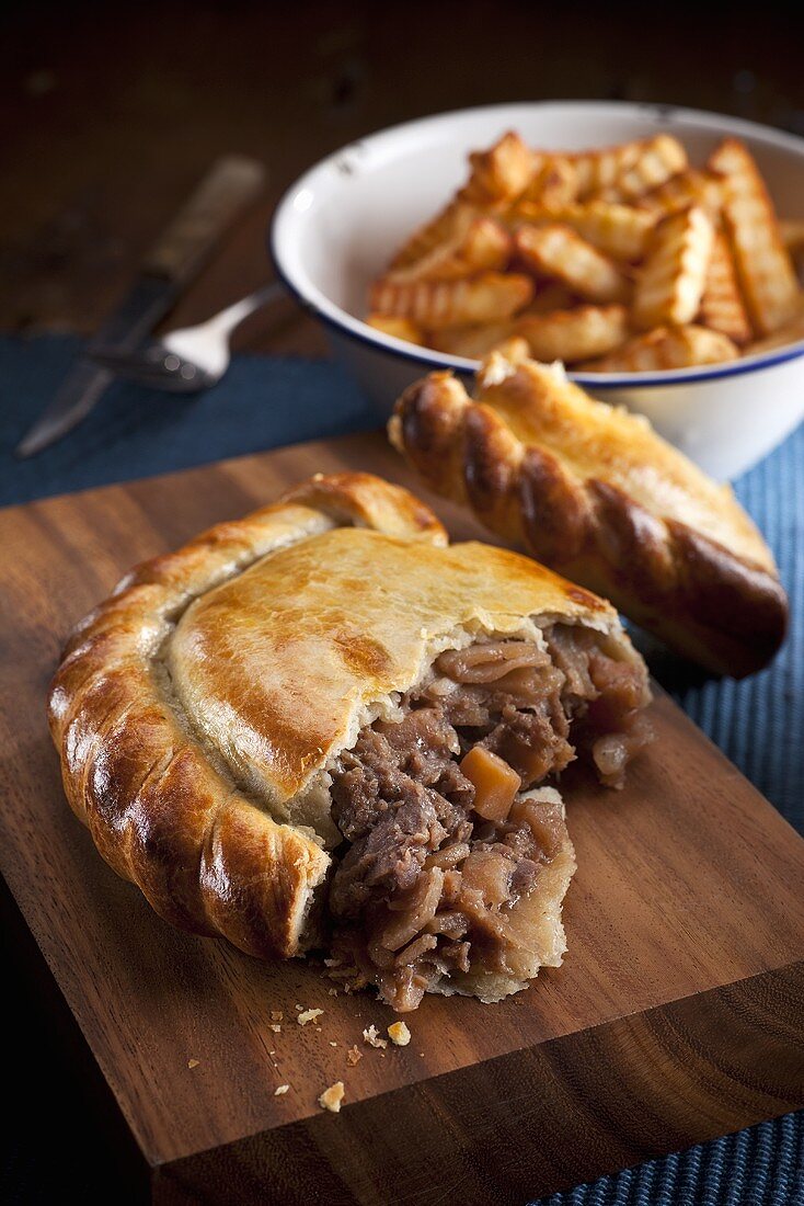 Steak pasty (English pastry), sliced open, with French fries