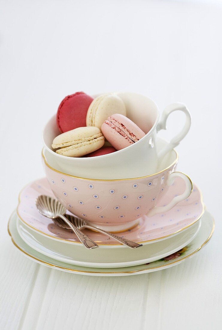 Macaroons in a pink tea cup