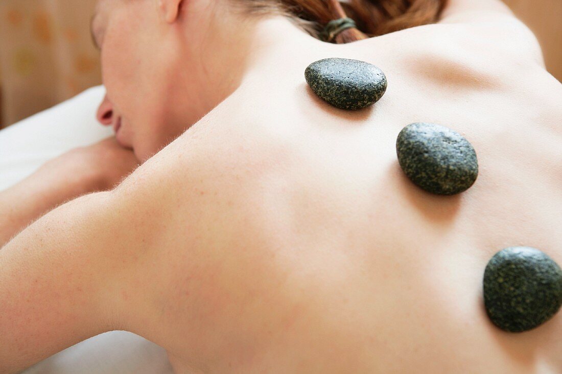 Stone theraphy in woman back