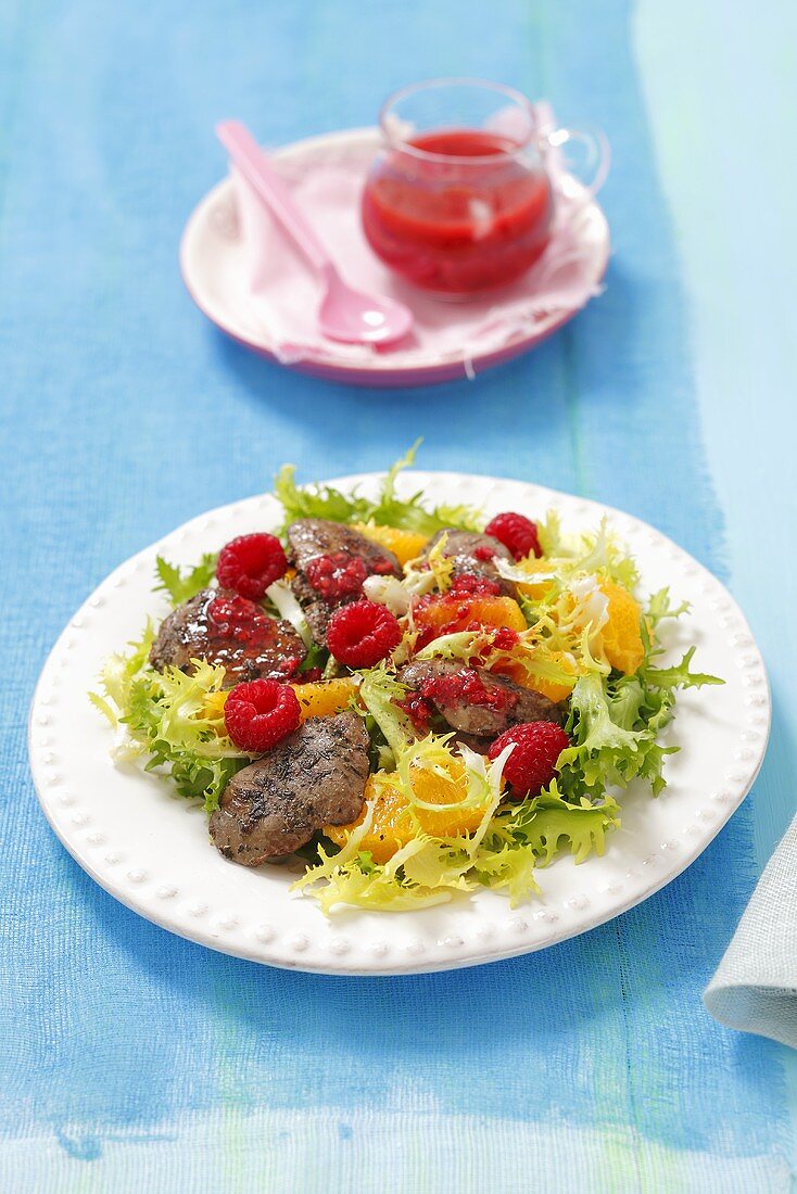 Frisee salad with chicken liver, orange, raspberries and raspberry dressing