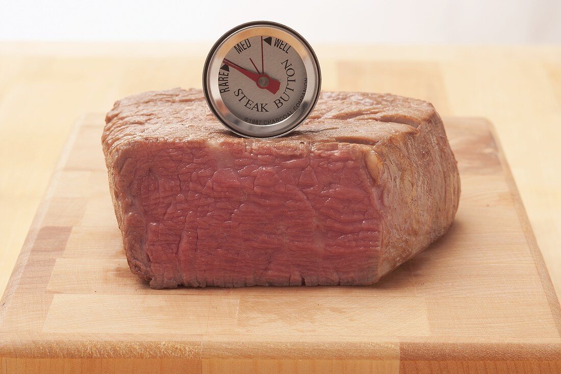 The core temperature of a beef steak being taken (rare)