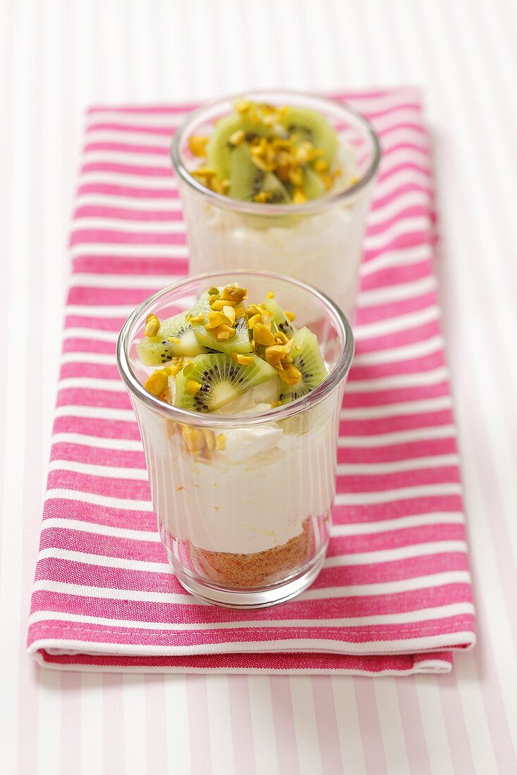 Cheesecake in glasses with kiwis and pistachios