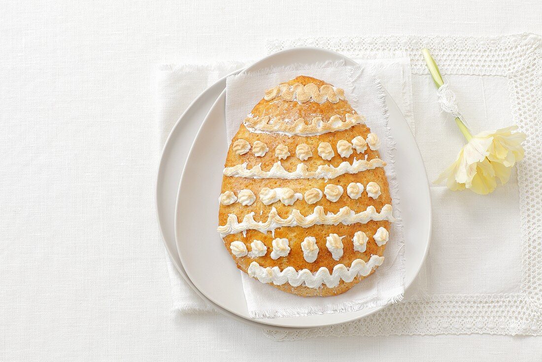 An egg-shaped almond biscuit with decorated with meringue