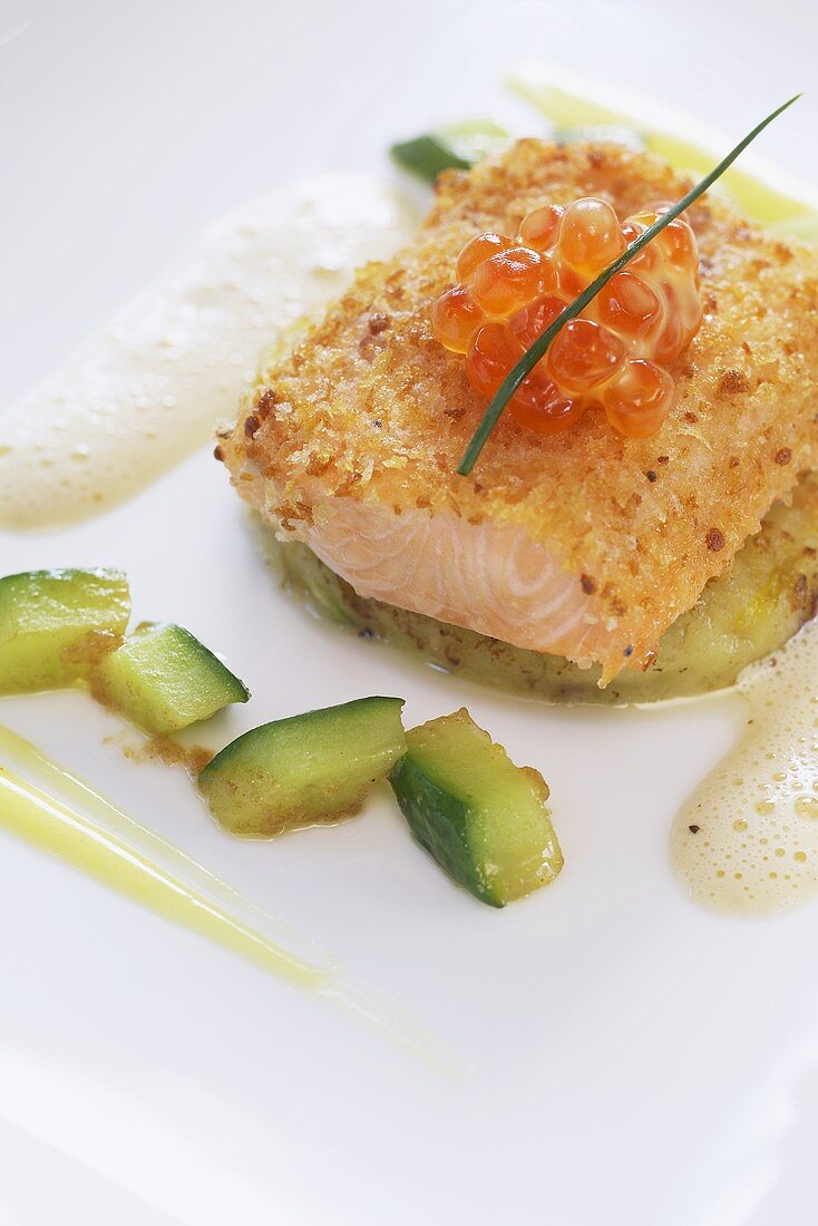 Salmon trout á la viennoise with cucumber on a bed of mashed potatoes