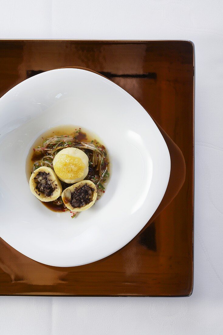 Black pudding dumpling on marinated radishes