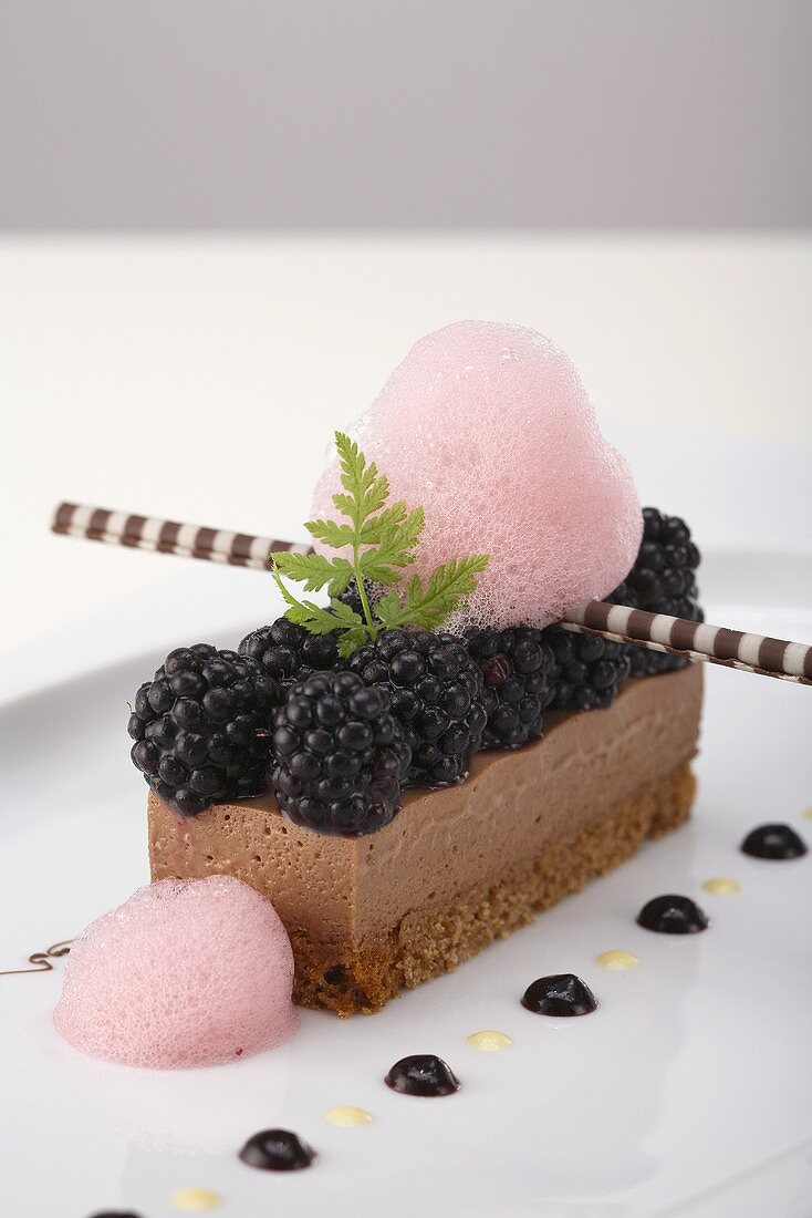 Chocolate slice with blackberries and blackberry foam