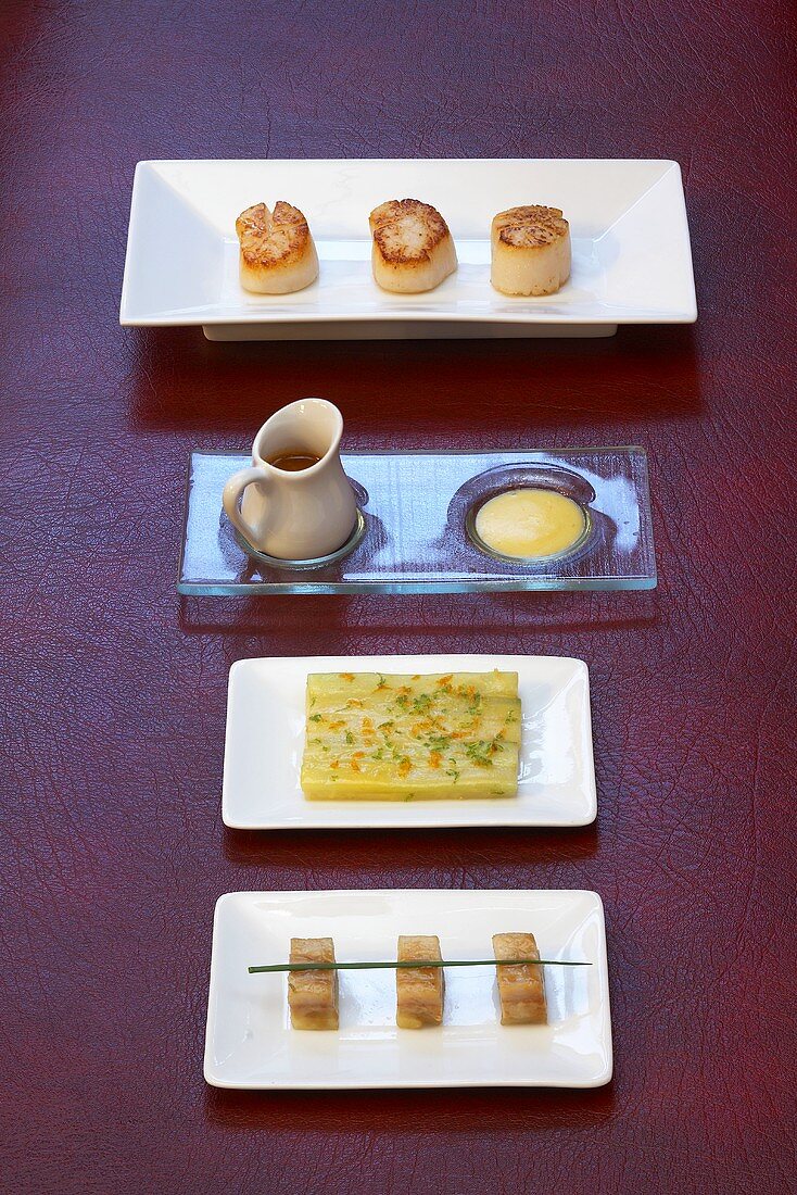 A variety of appetizers (scallops, sauce Maltaise, celery and asparagus carpaccio)