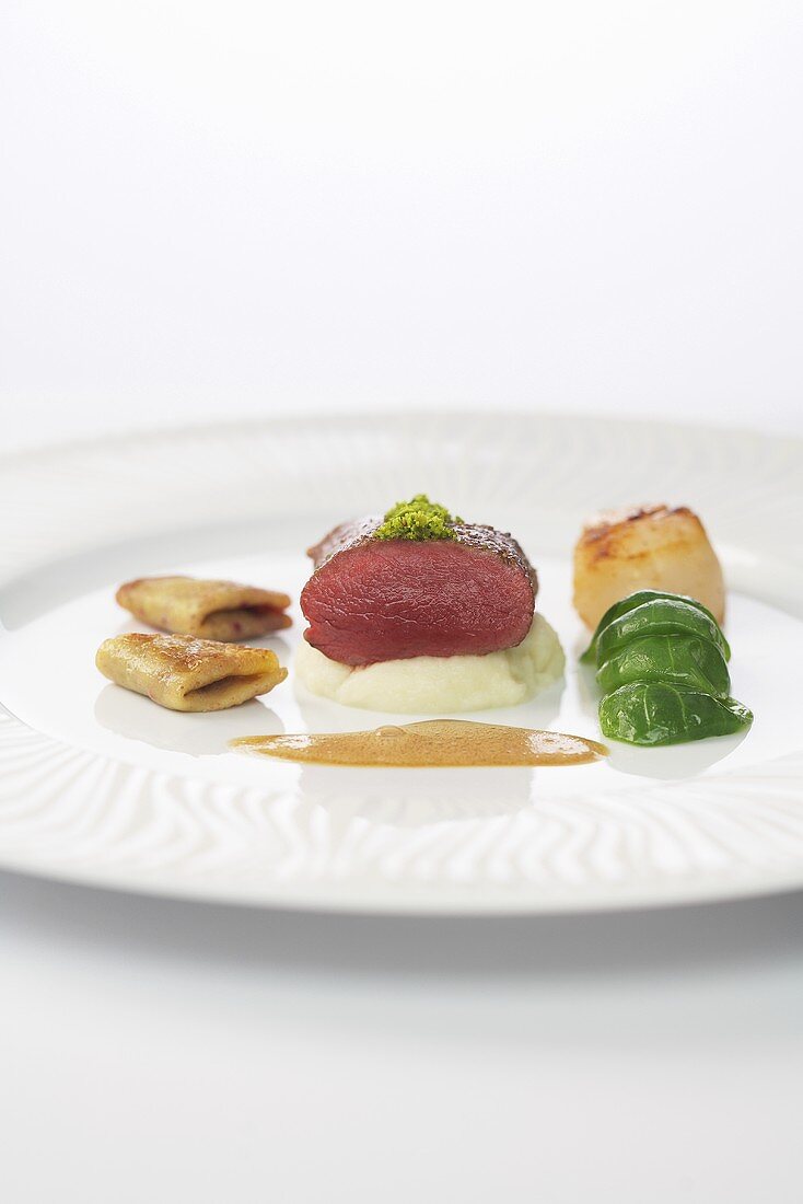 Saddle of venison and fried scallops with celery puree