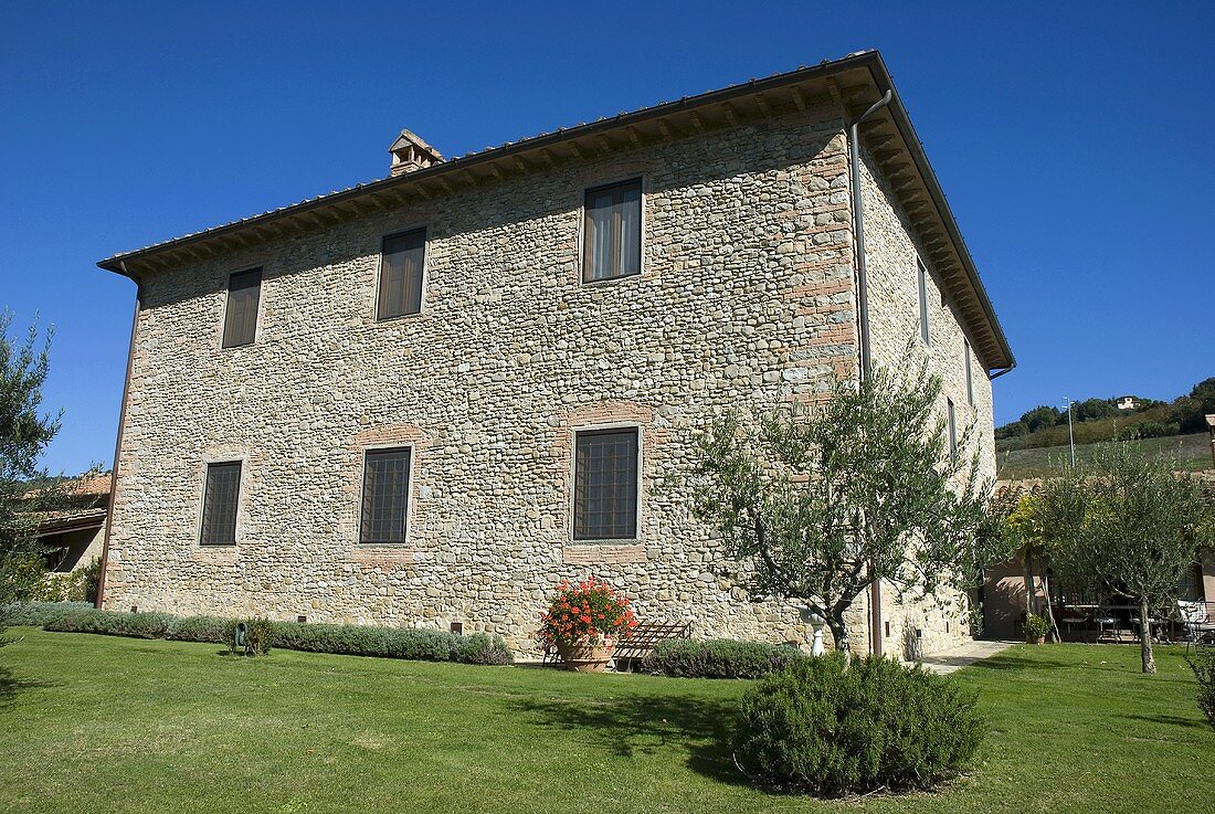 Mediterranean country home with stone facade and garden