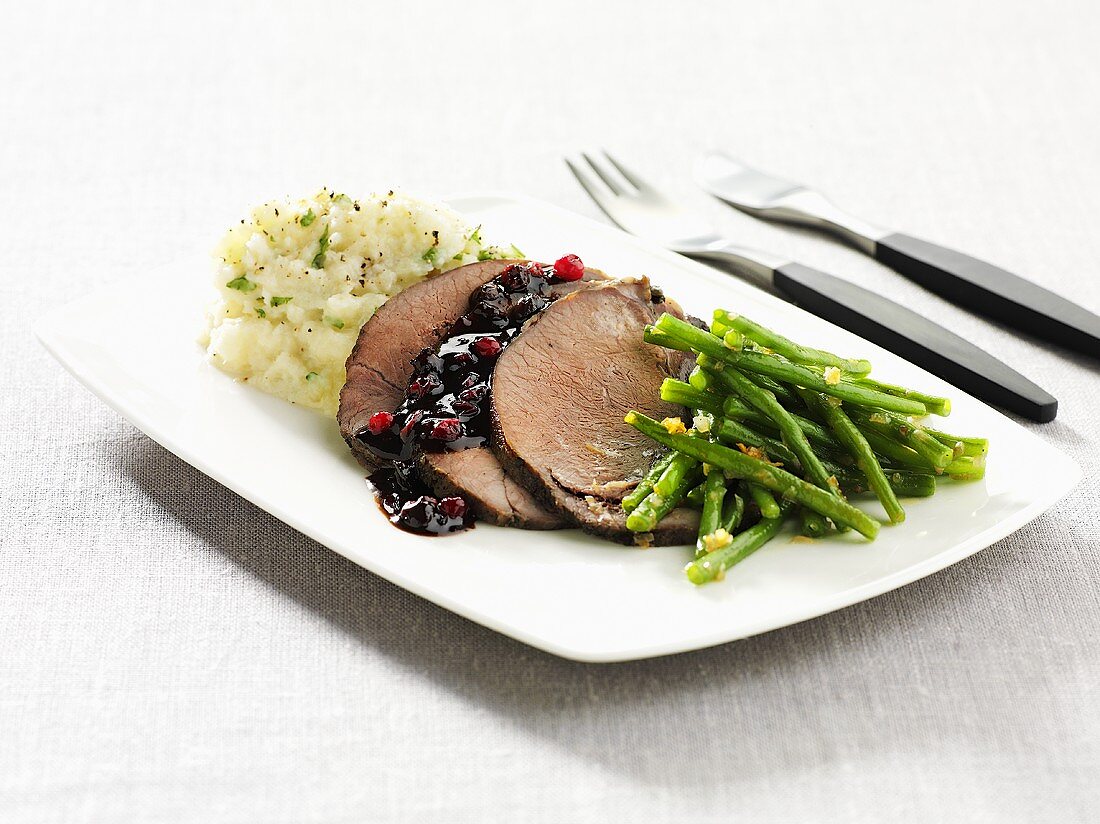 Roast wild boar with lingonberry sauce and green beans