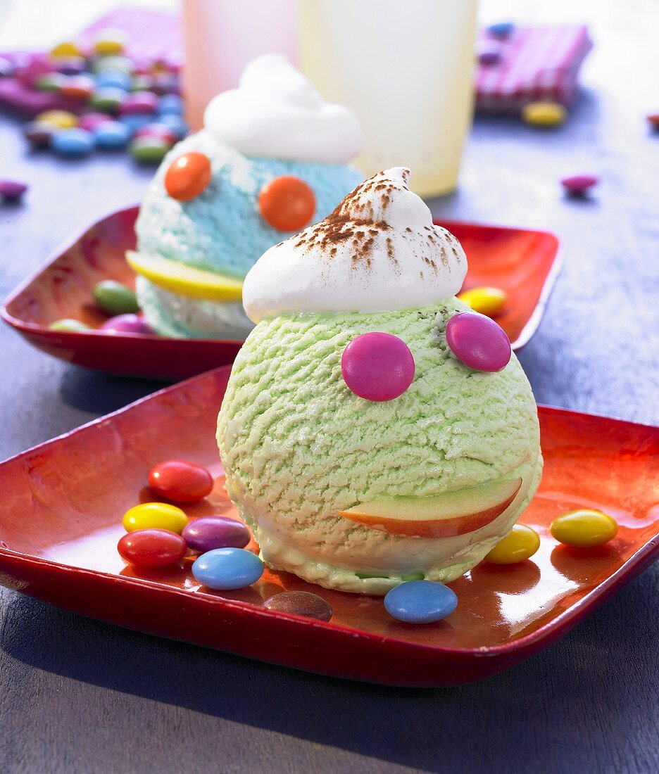 Green and blue ice cream decorated with colourful chocolate beans
