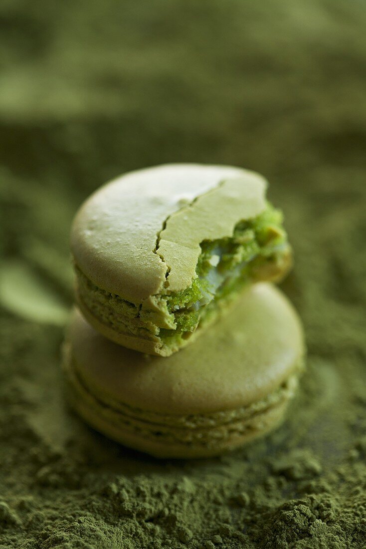 Matcha macaroons, one with a bite taken out