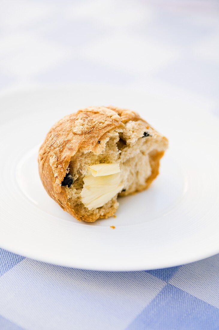 A piece of a pumpkin seed roll with butter