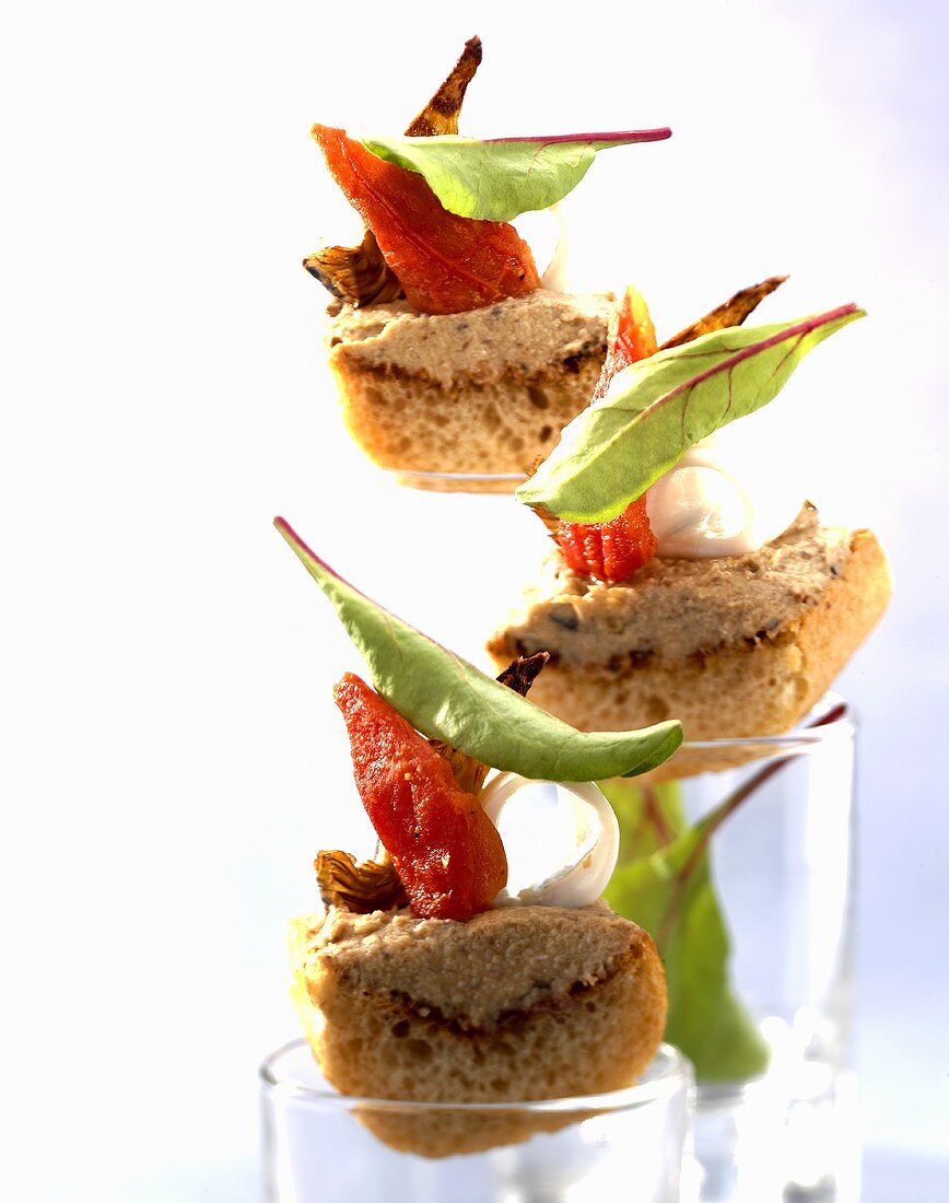 Canapes with olive tapenade, baby squid and tomato confit