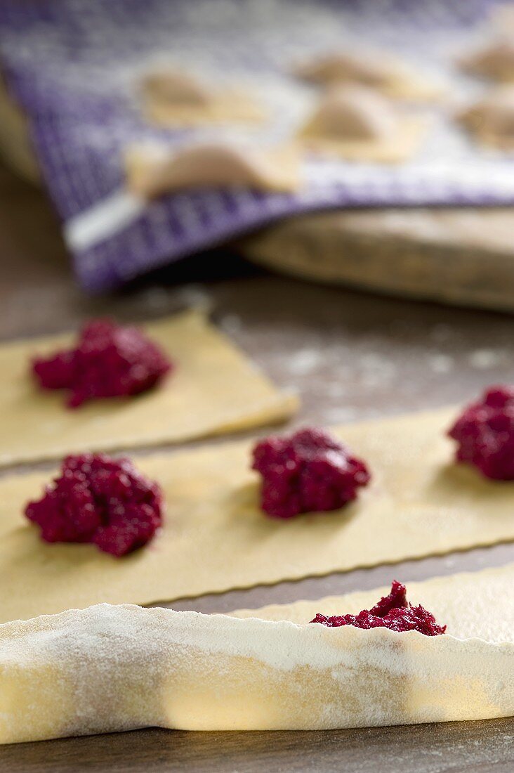 Ravioli with beetroot filling being made