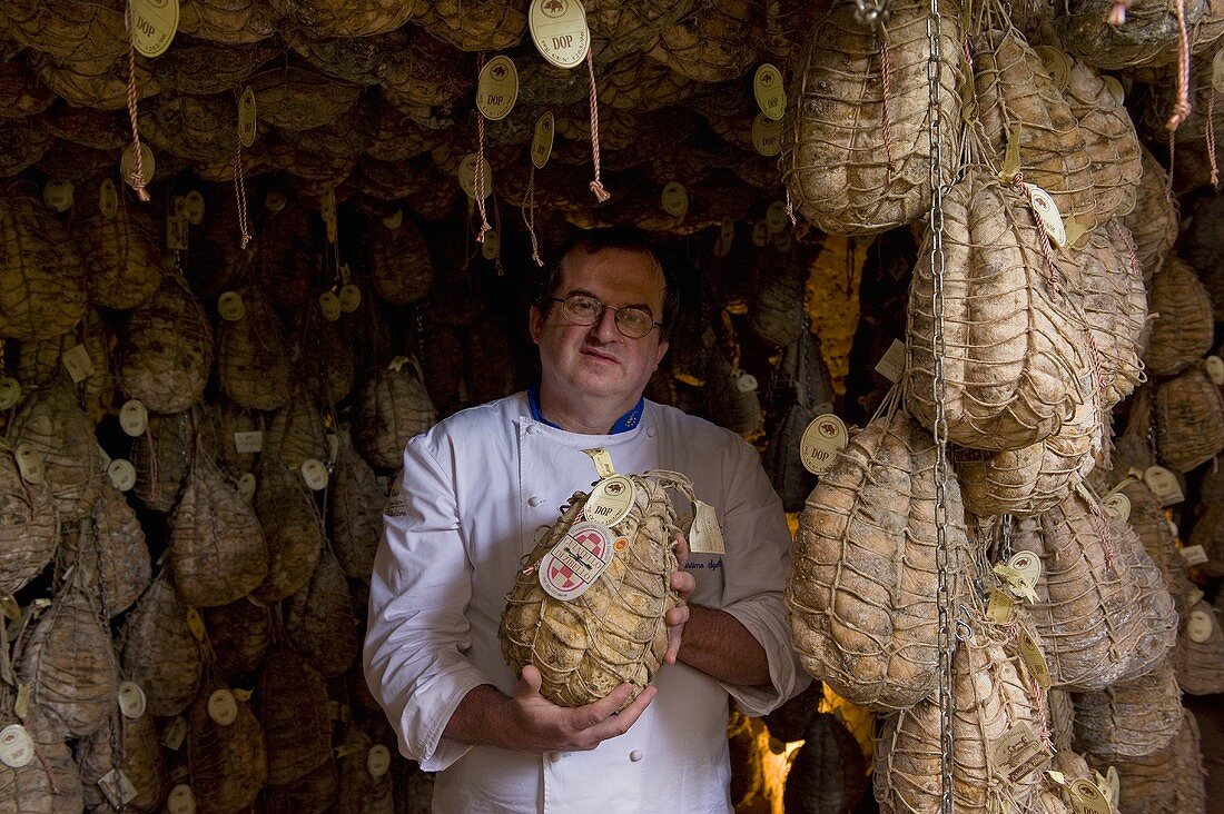 A butcher presenting Culatello di Zibello (ham speciality, Emilia Romagna, Italy)
