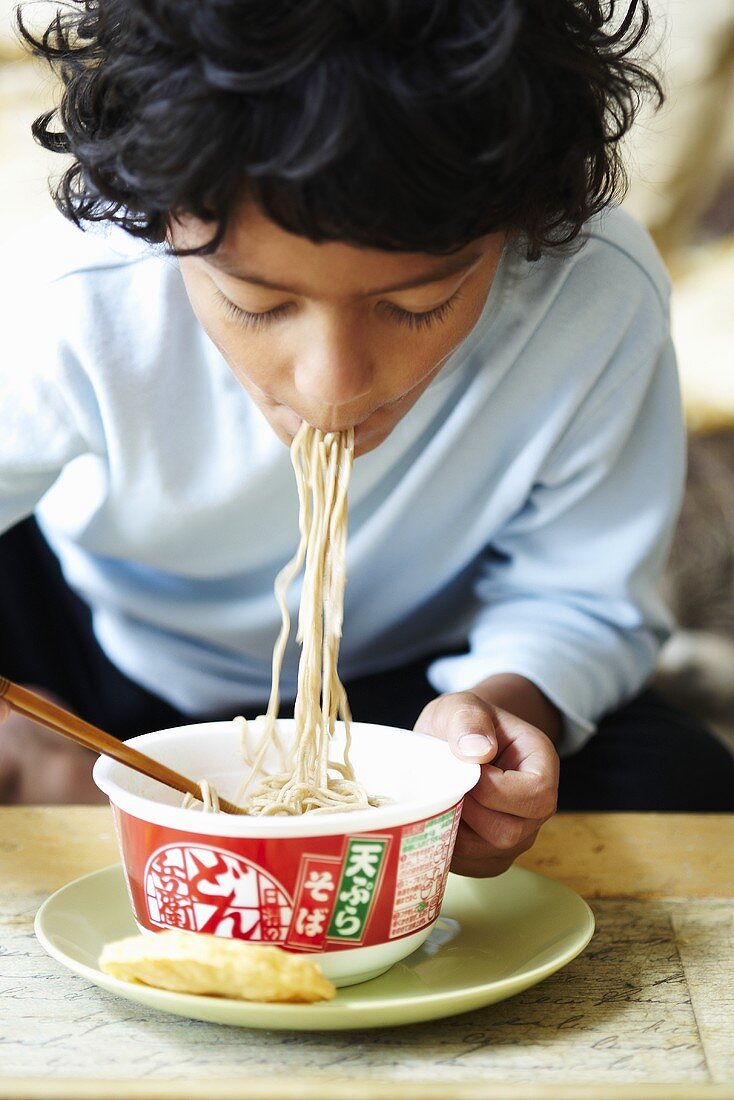 A child eating noodles