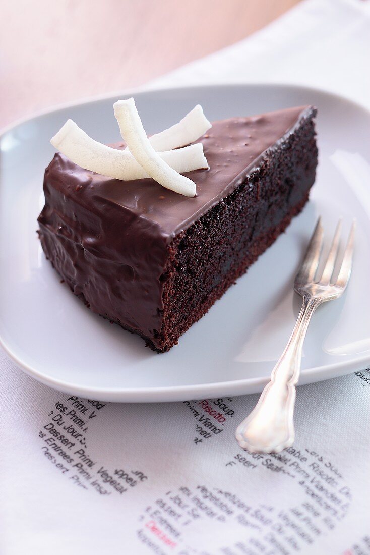 A slice of chocolate cake with coconut