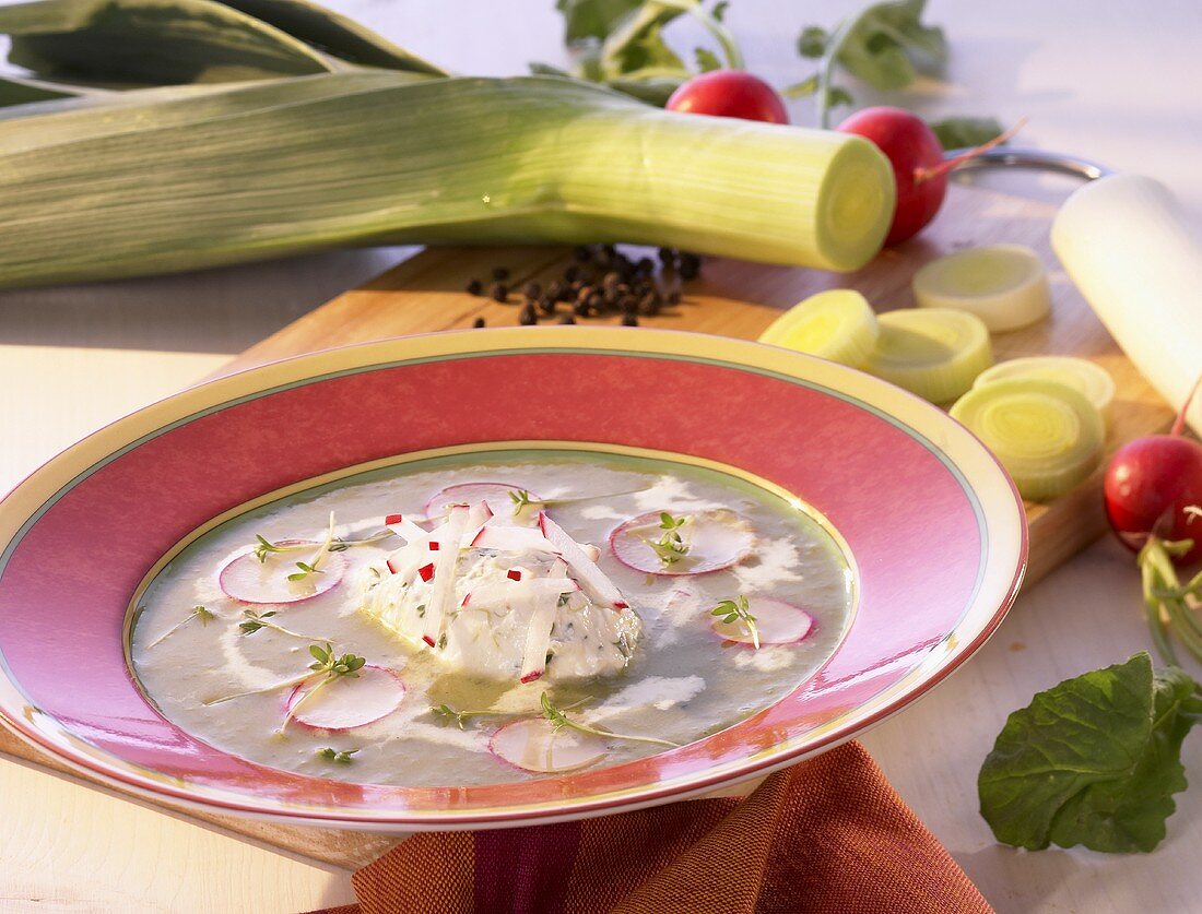 Cream of leek soup with cream cheese dumplings and radishes