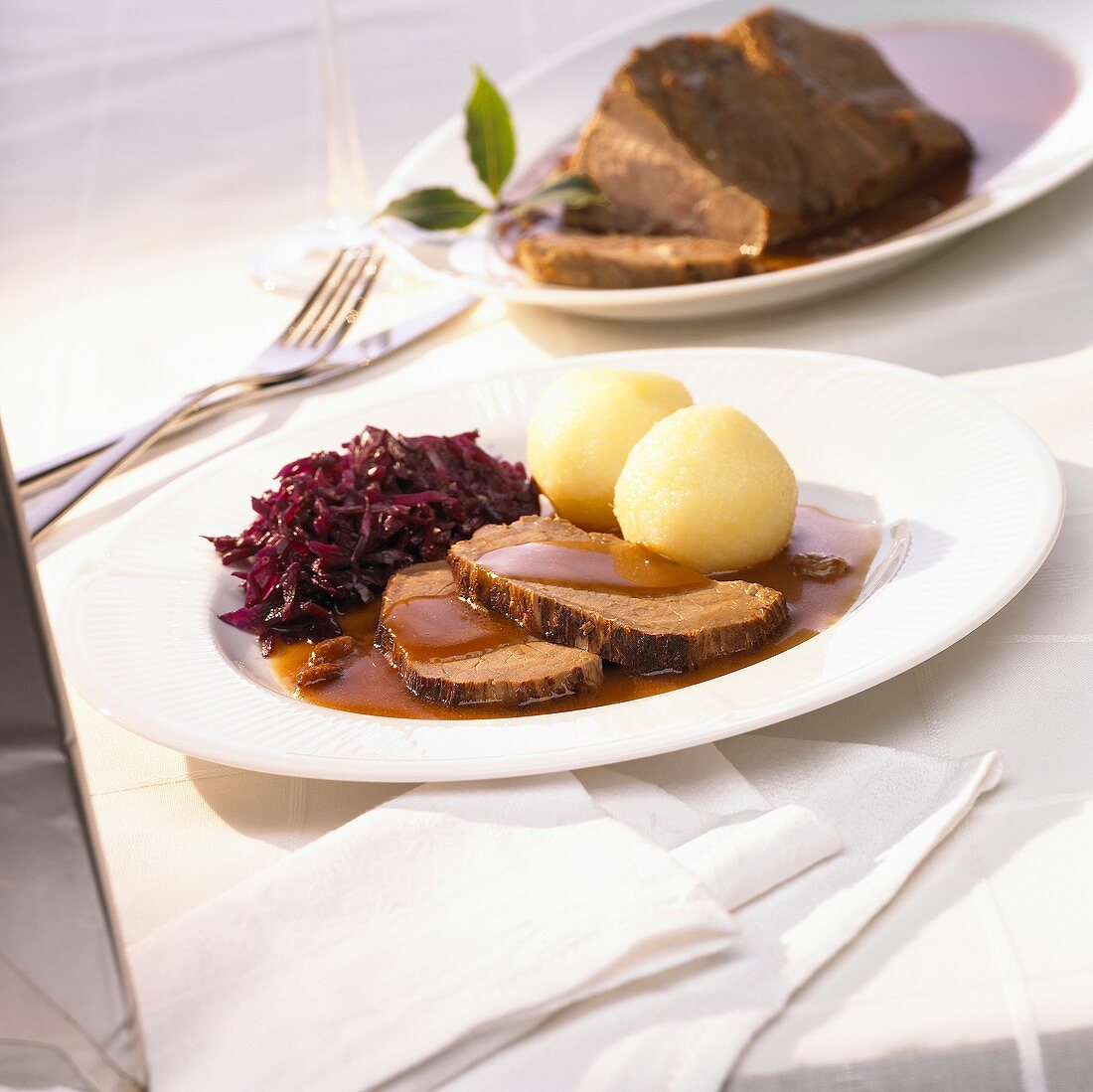 Rhineland Sauerbraten (braised beef in vinegar) with red cabbage and potato dumplings