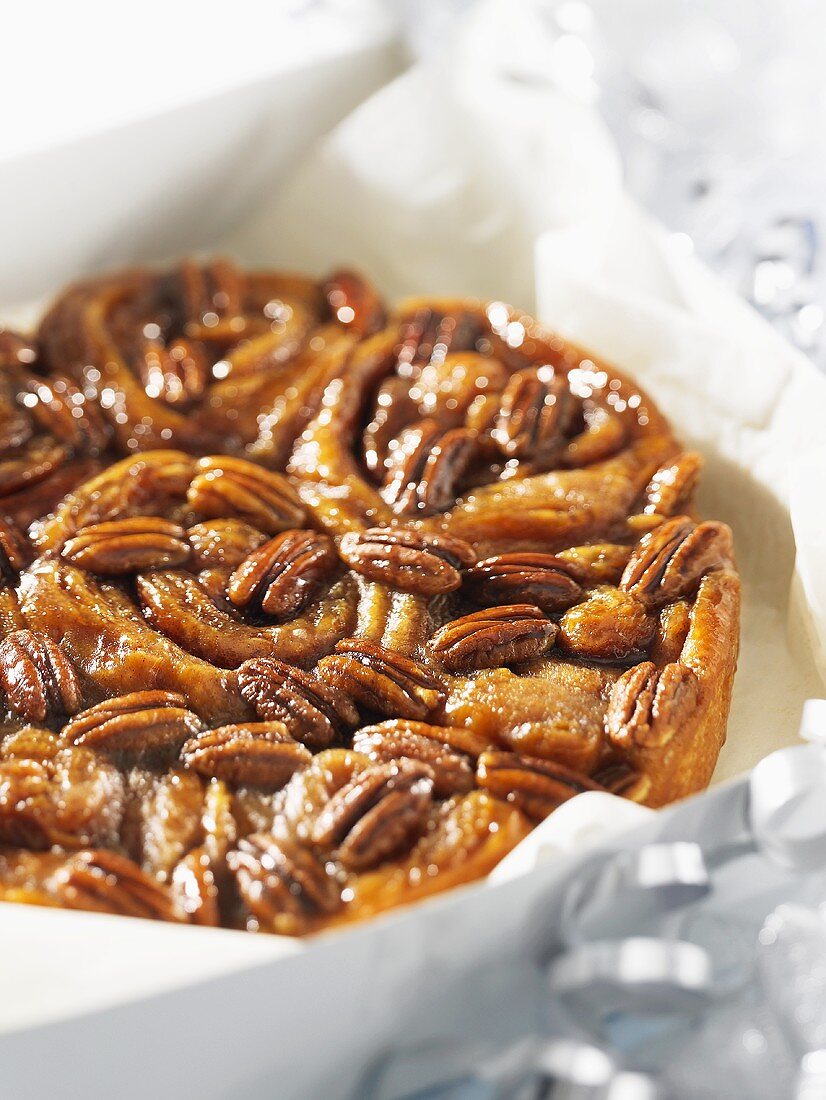 Sticky buns with pecan nuts in a box as a gift