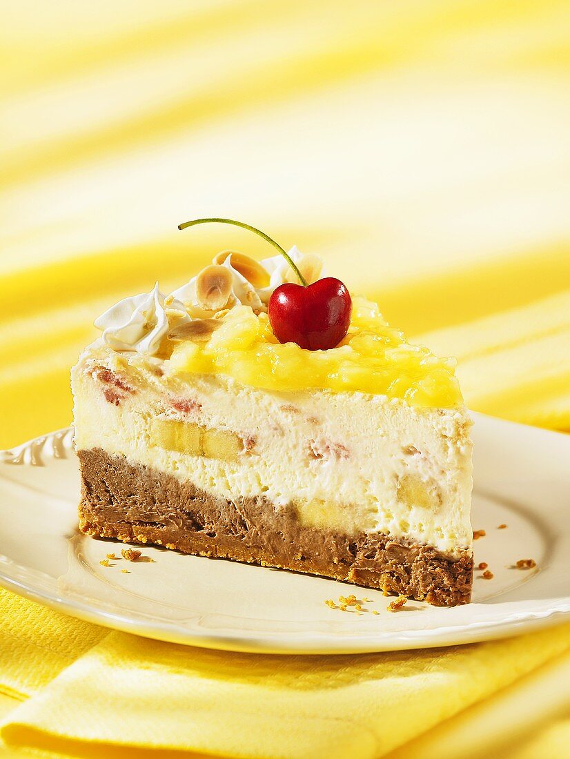 A slice of pineapple and banana split ice cream cake