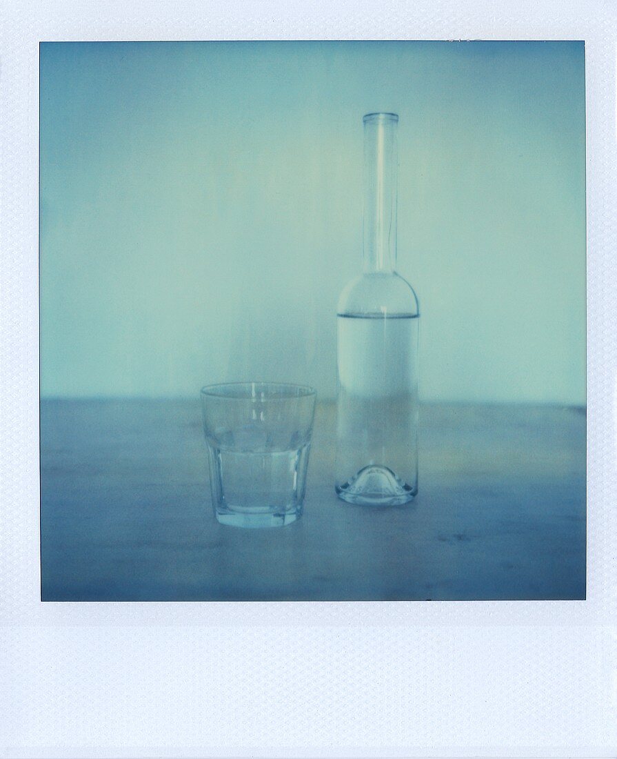 A bottle of water and a glass
