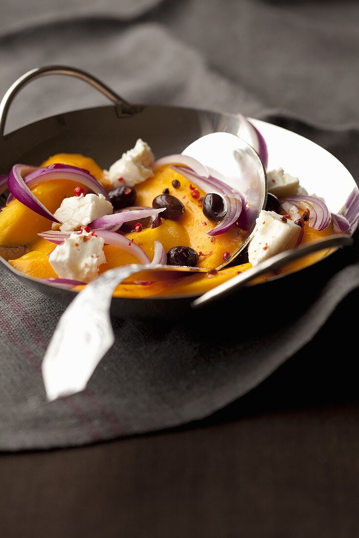 Mango and feta stir fry with red onions and olives