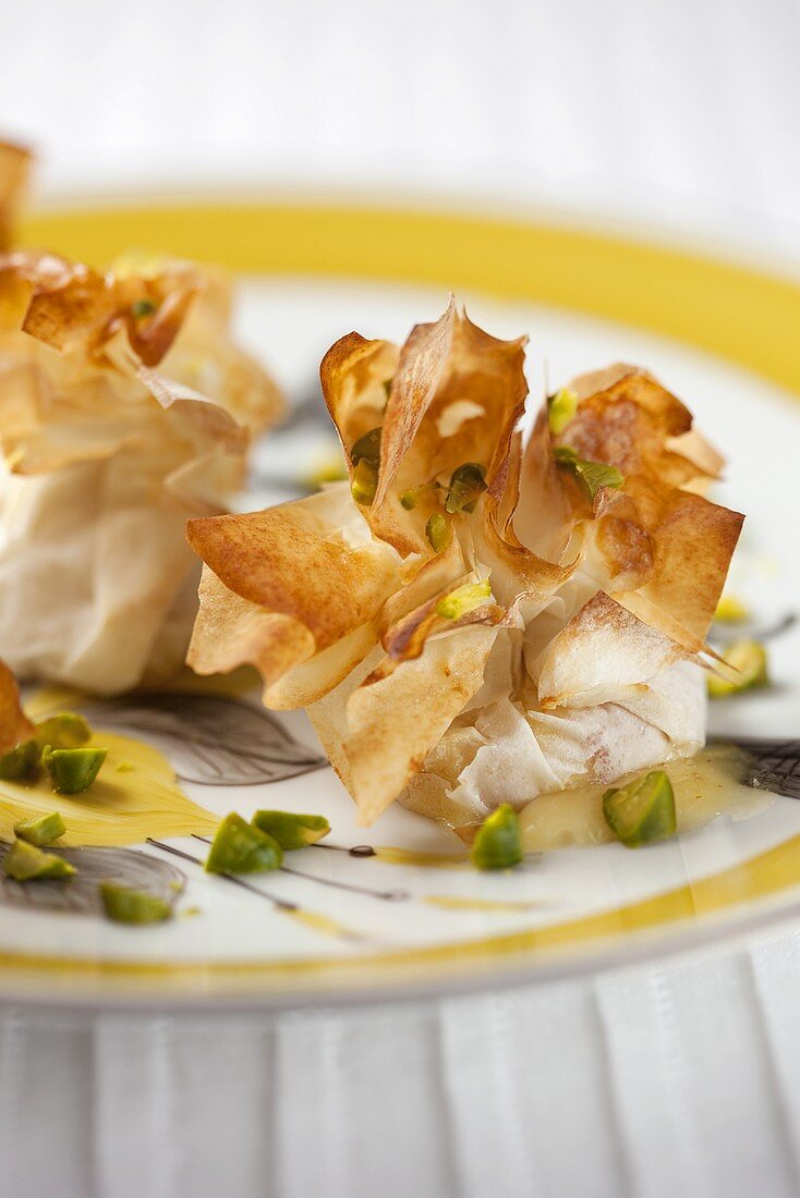 Pastry pockets filled with bacon and pistachios