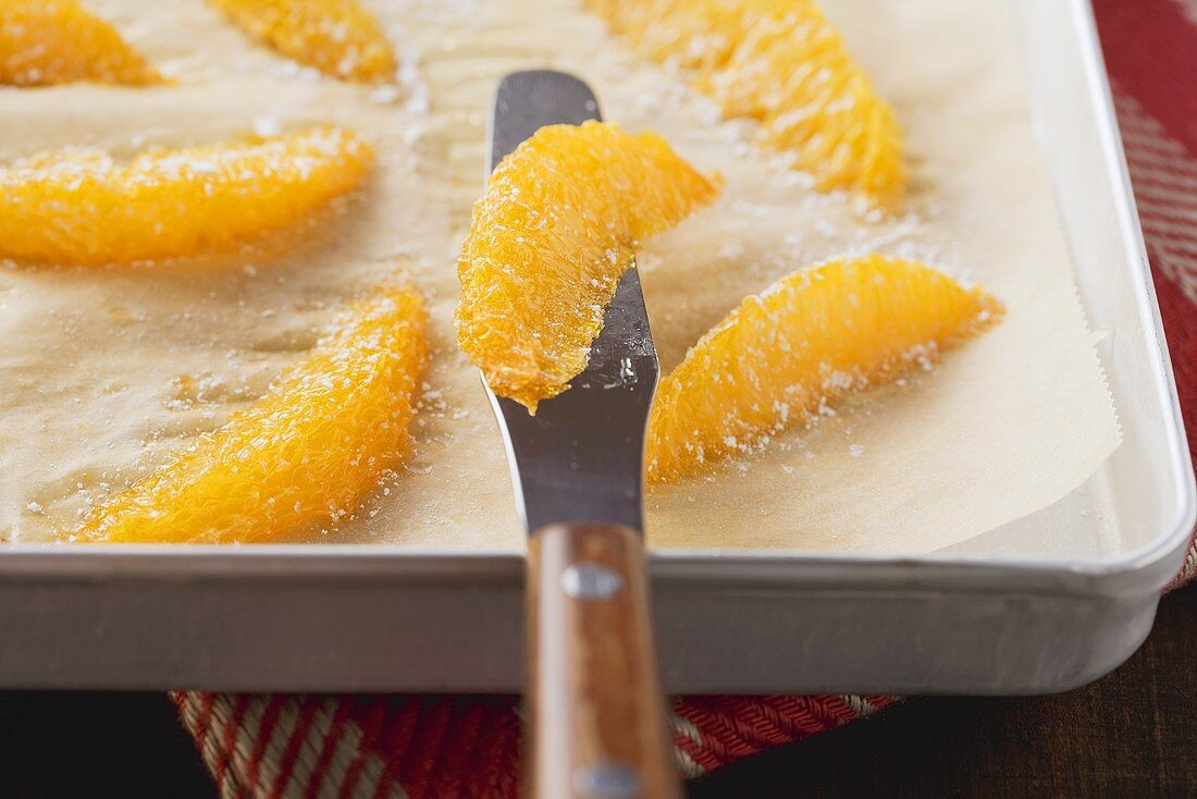 Orange fillets being dried in an oven