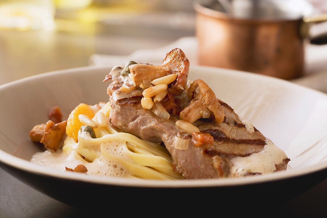 Veal with pasta and orange and chanterelle mushroom sauce