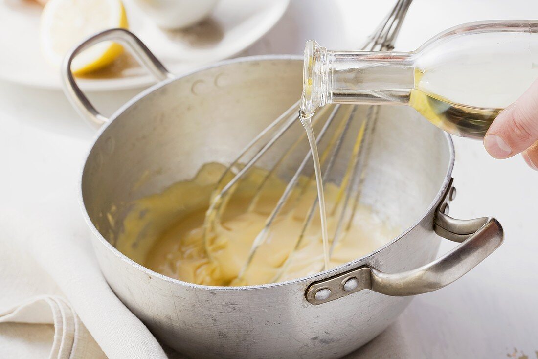 Mayonnaise being made: oil being stirred into the egg-mustard mixture