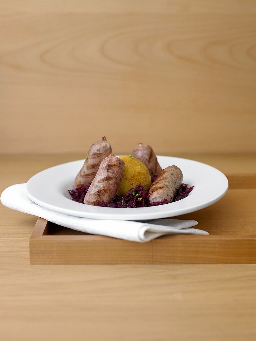 Duck sausages with red cabbage and noodles