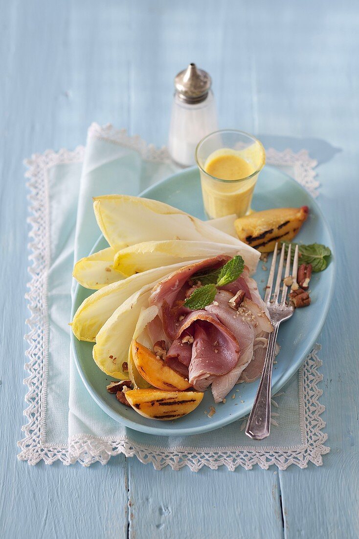 Smoked ham with grilled peach and chicory leaves