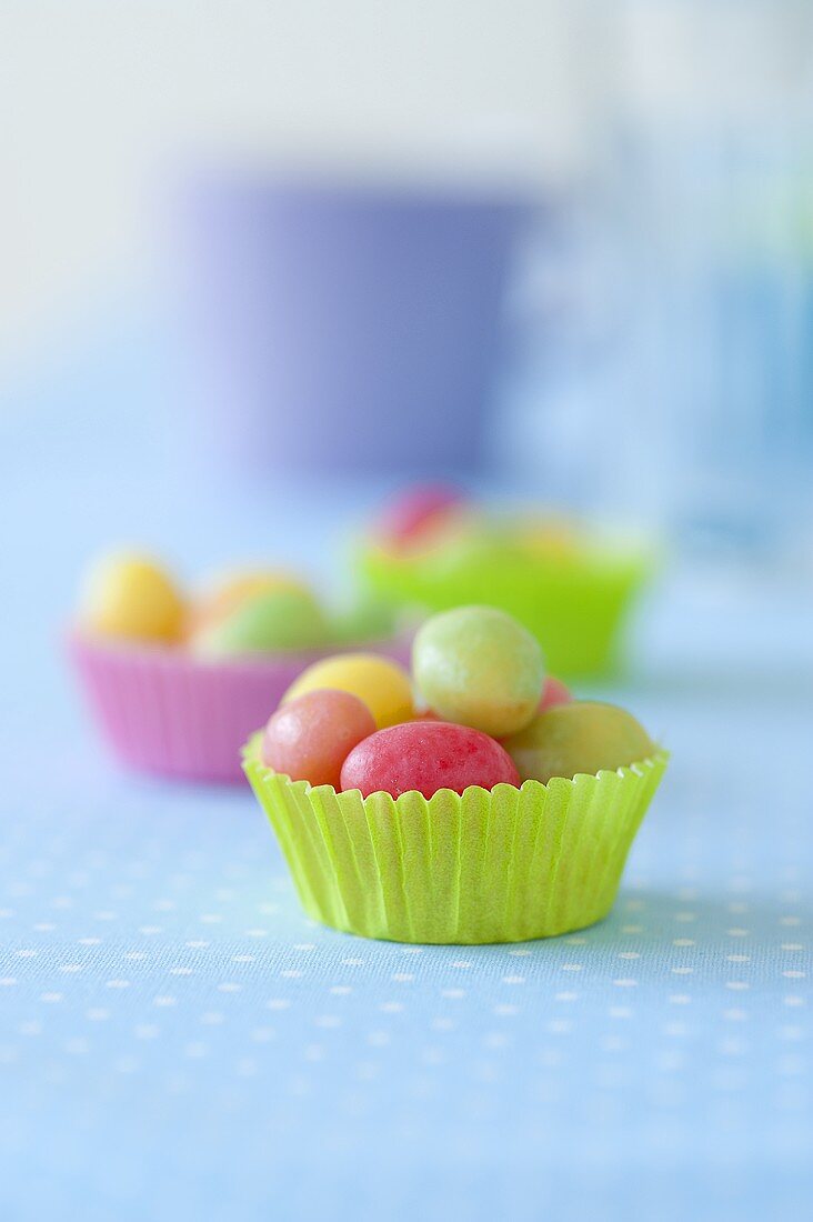 Colorful sugar eggs in muffin cups