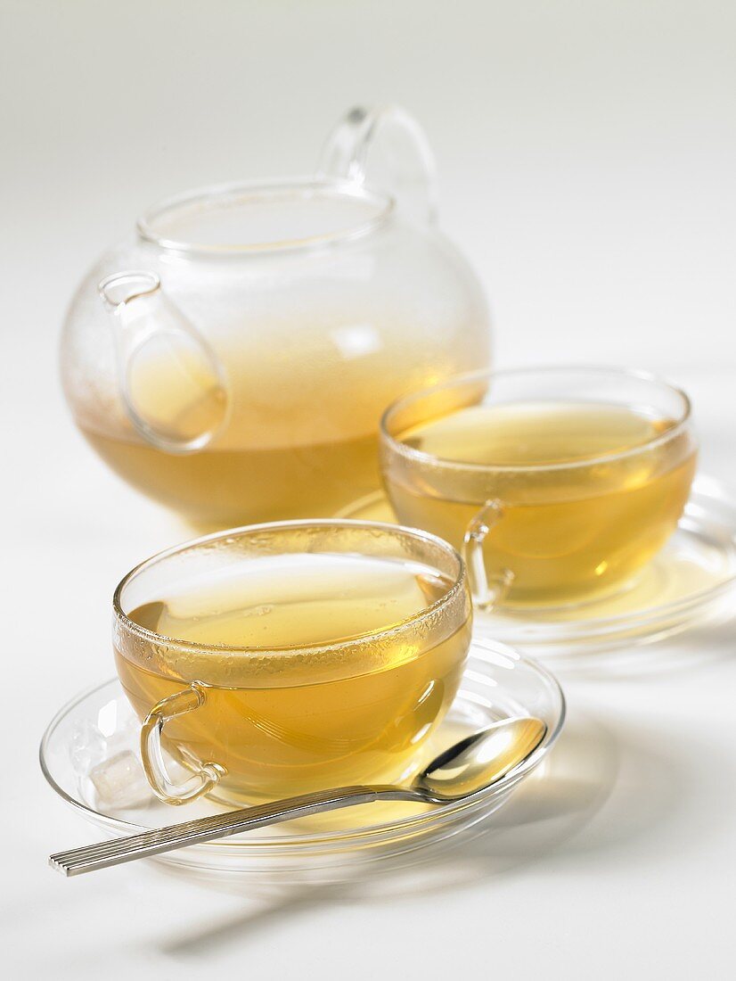 Tea in glass cups and a glass teapot