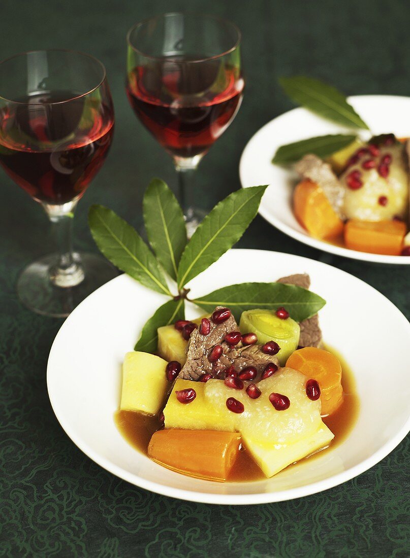 Boiled fillet of beef with vegetables, applesauce and pomegranate seeds