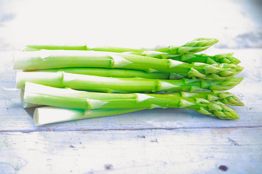 Green asparagus on wooden background