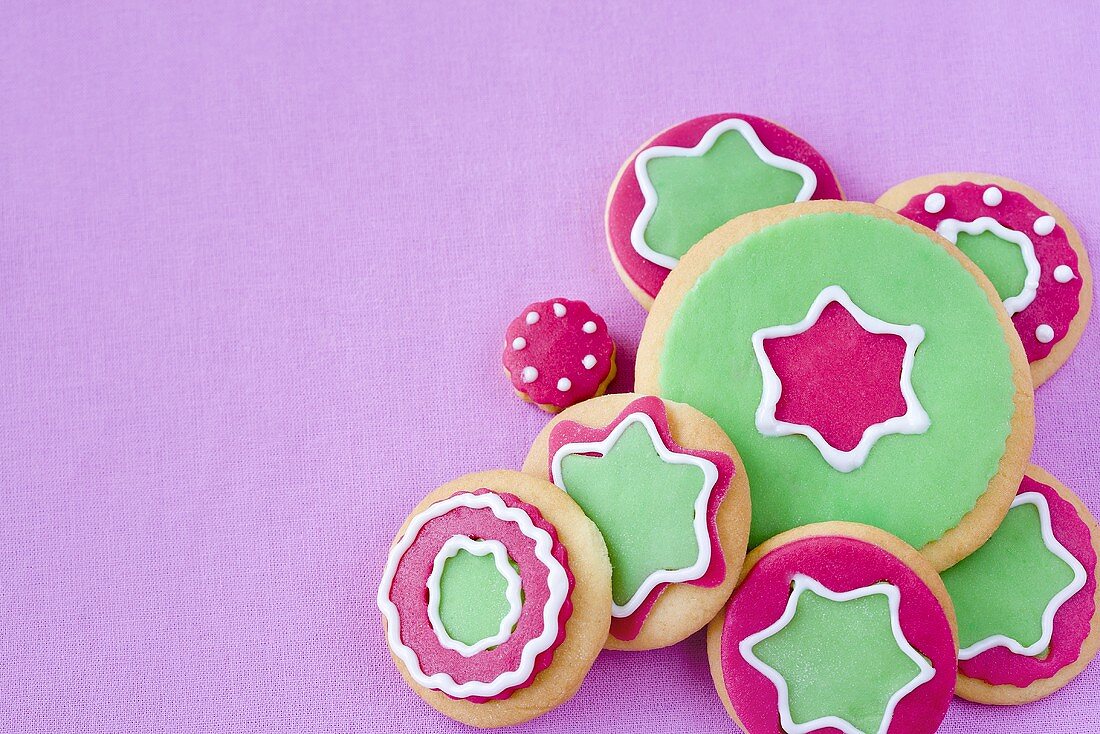 Colorfully decorated Christmas cookies on a purple background