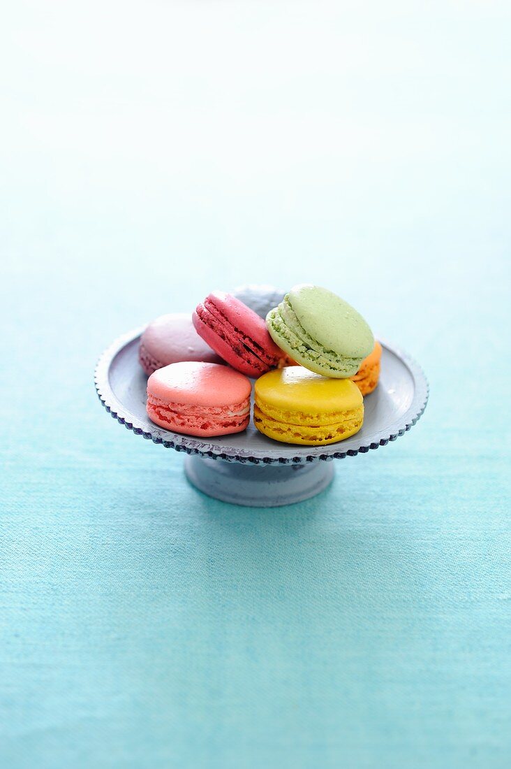 Several types of macaroons on a cake stand