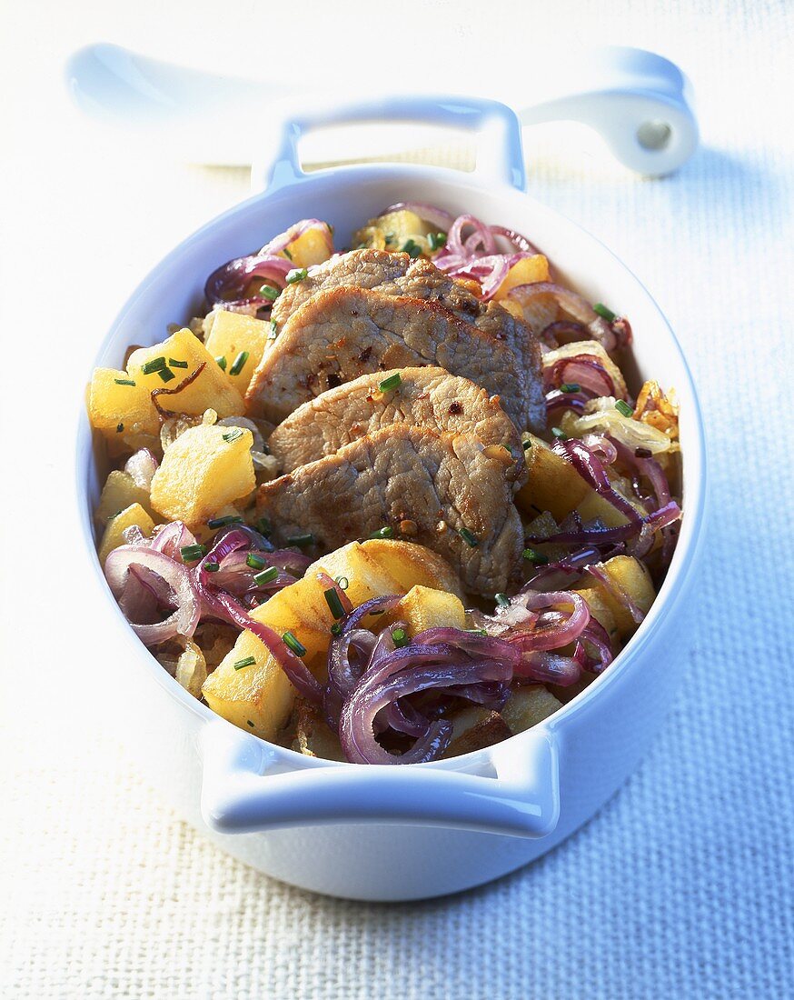 Veal with potatoes and onions in a roaster