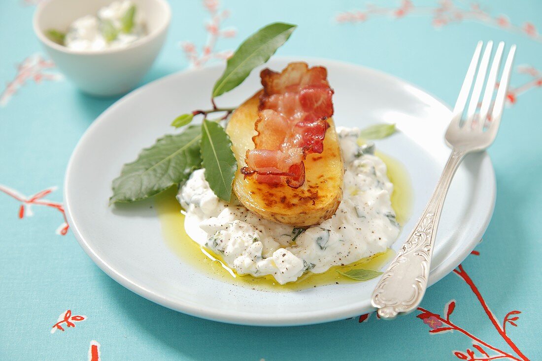 Baked potato with bacon on herb quark (curd)