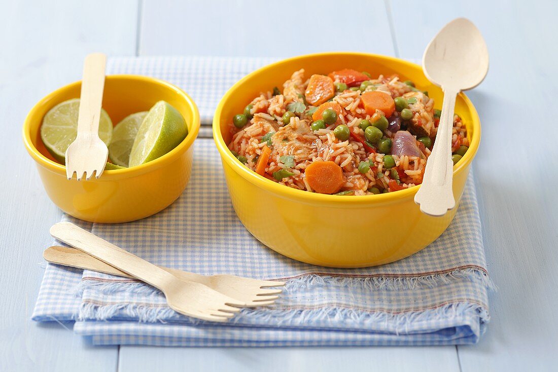 Rice with chicken, carrots, peas, limes