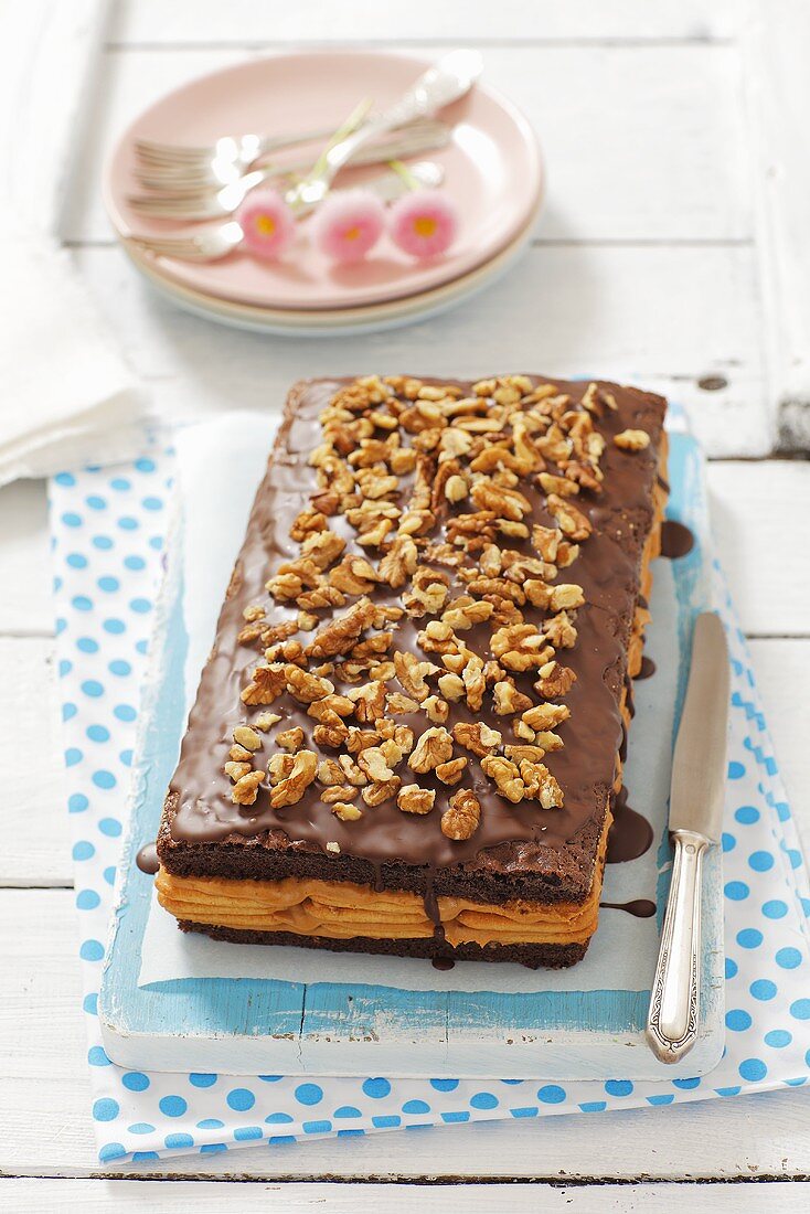 Chocolate biscuit cake with crackers, caramel and nuts