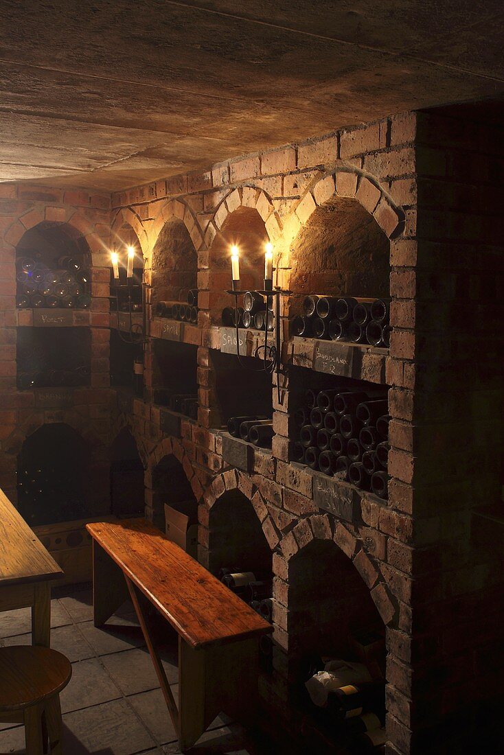 Bottles and candles in a wine cellar (Nabygelen, Wellington, Western Cape)