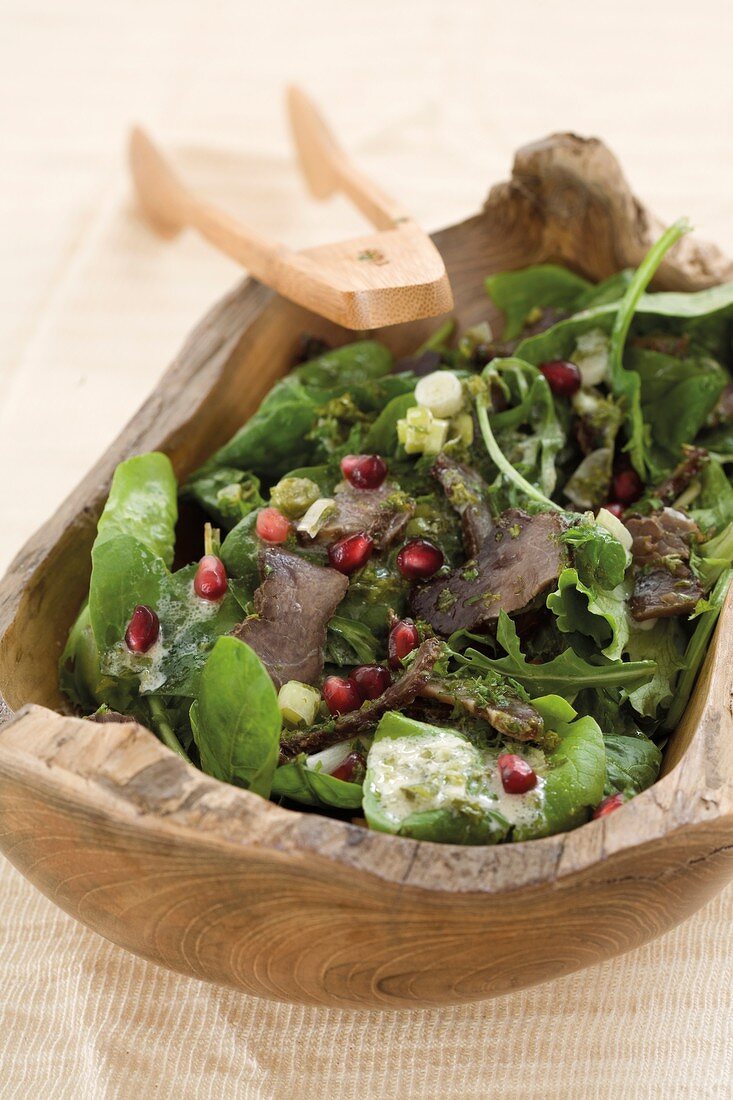 A green salad with biltong and pomegranate seeds