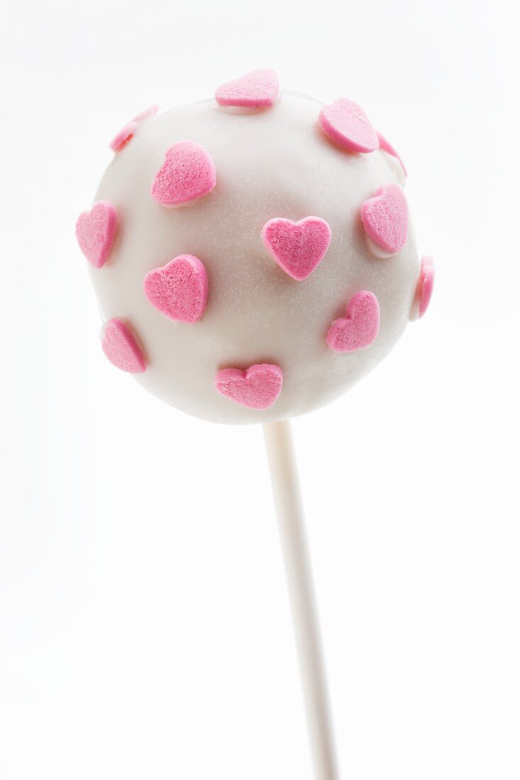 A white cake pop with pink sugar hearts